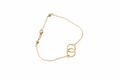 10k gold delicate cable chain bracelet with two interlocking open circles on white background