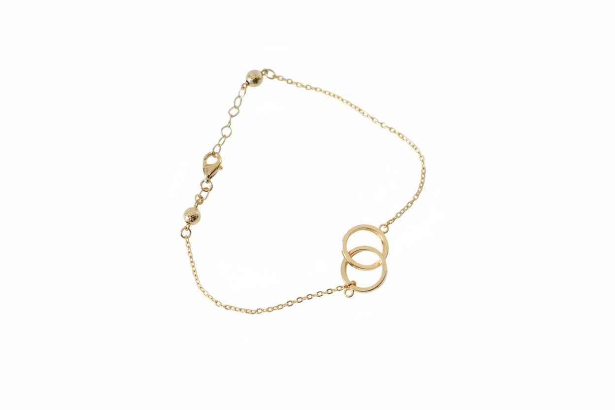10k gold delicate cable chain bracelet with two interlocking open circles on white background