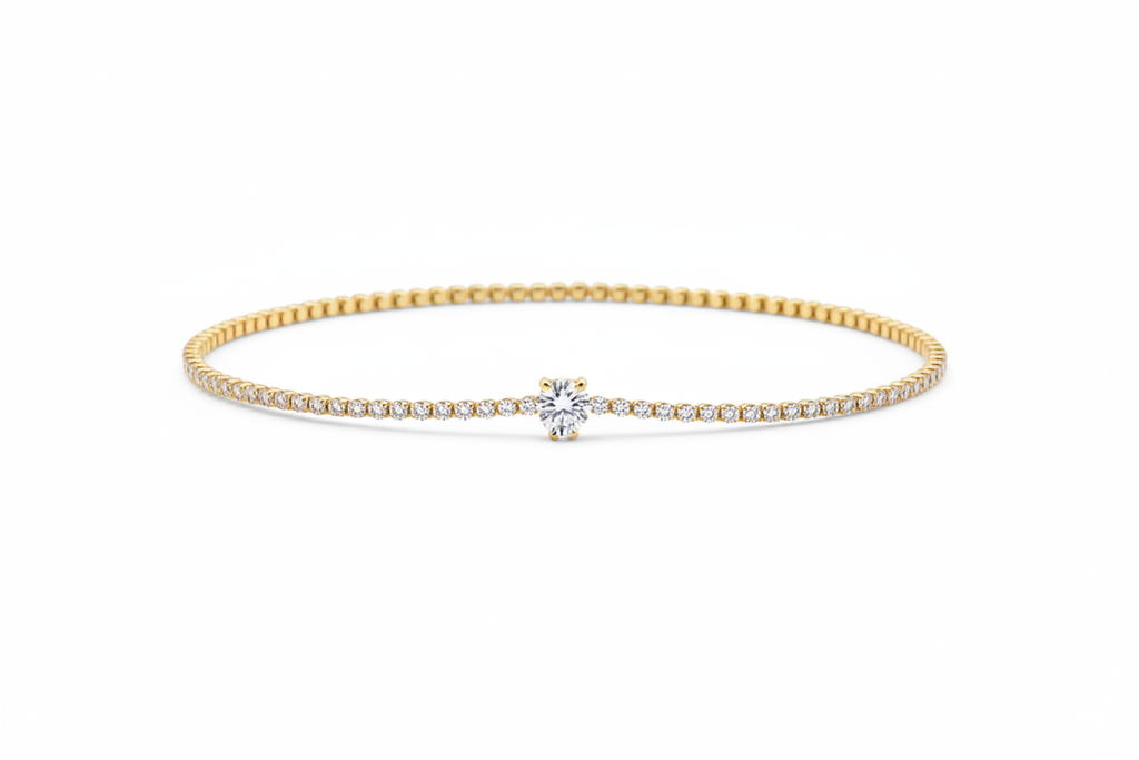 10k gold delicate pavé diamond tennis bracelet with round brilliant solitaire center on white background