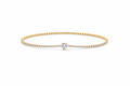 10k gold delicate pavé diamond tennis bracelet with round brilliant solitaire center on white background