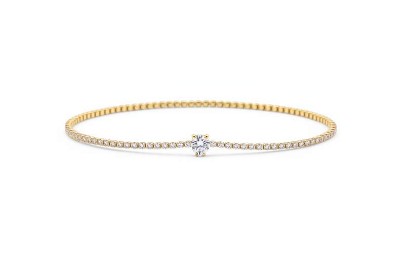 10k gold delicate pavé diamond tennis bracelet with round brilliant solitaire center on white background