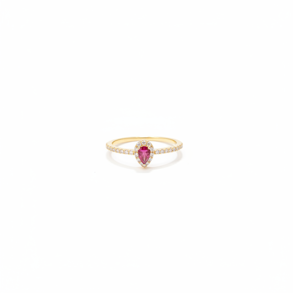 10k gold pear ruby ring with diamond band on white background