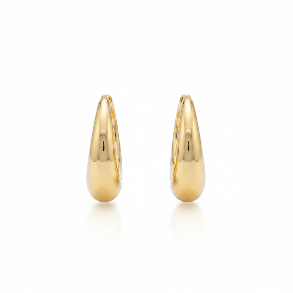 10k gold chunky oval huggie hoop earrings on white background