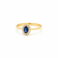 10k gold oval sapphire ring with diamond halo on white background